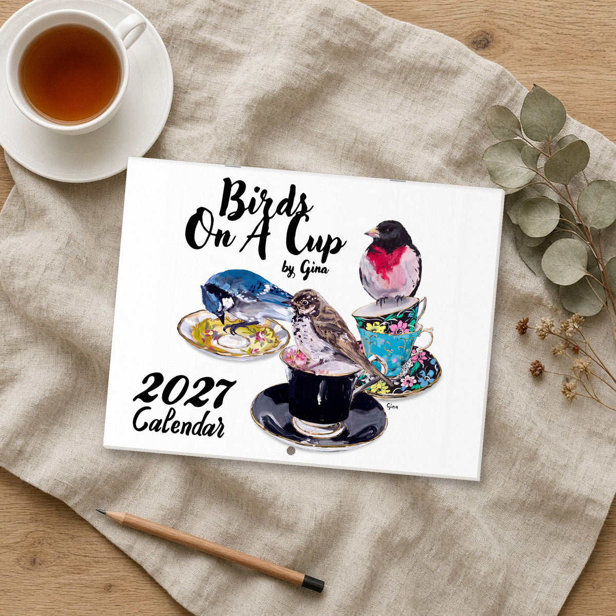 2027 Birds On A Cup Fold-Out Wall Calendar with tea cup on linen